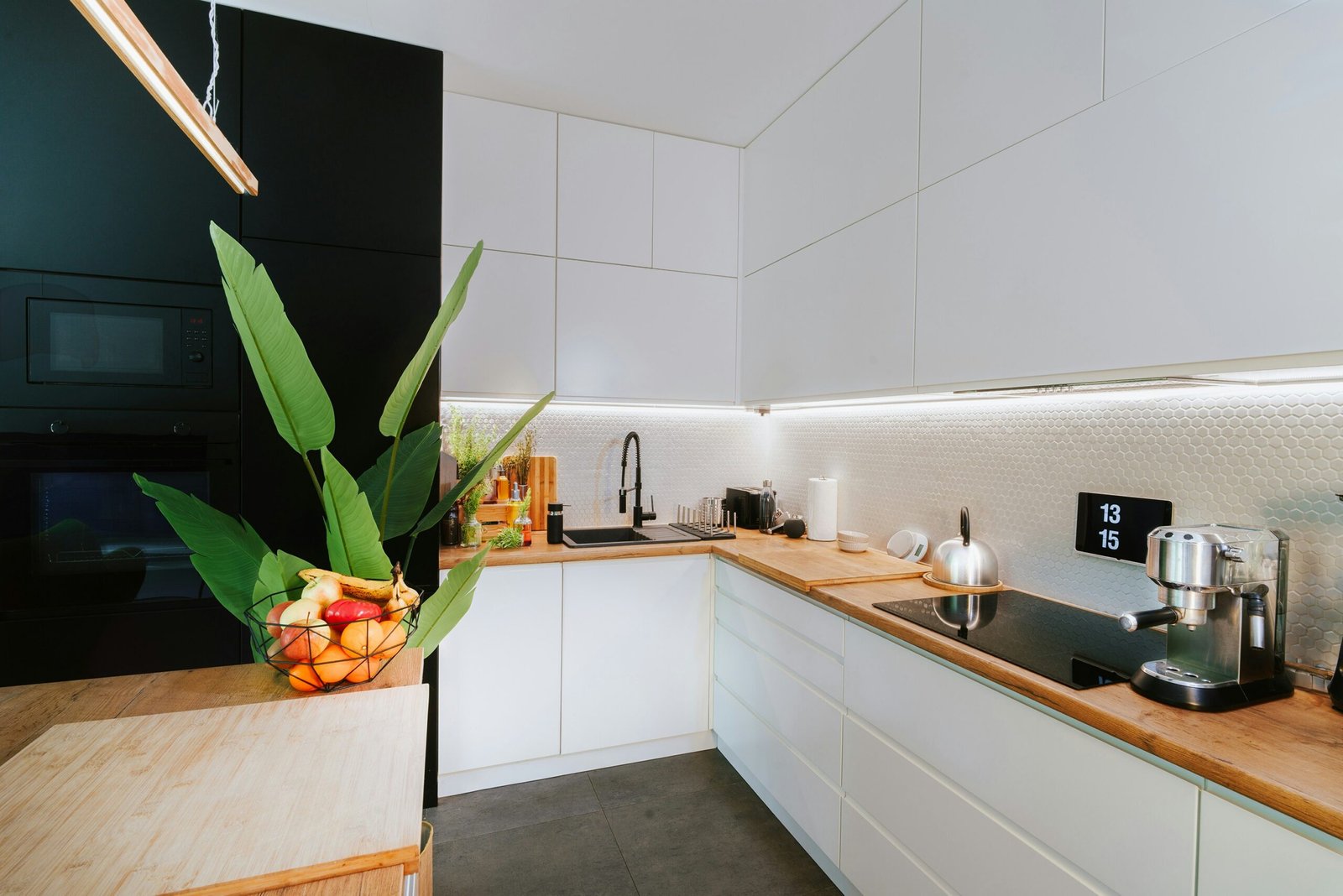 A kitchen with a plant in the middle of the counter